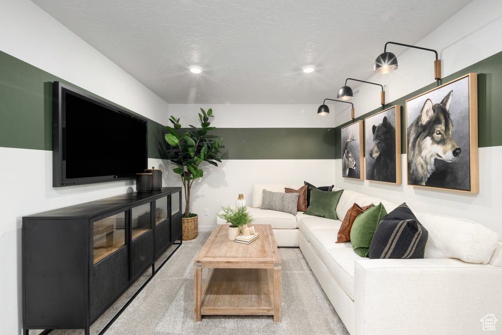 Living room with recessed lighting and light colored carpet