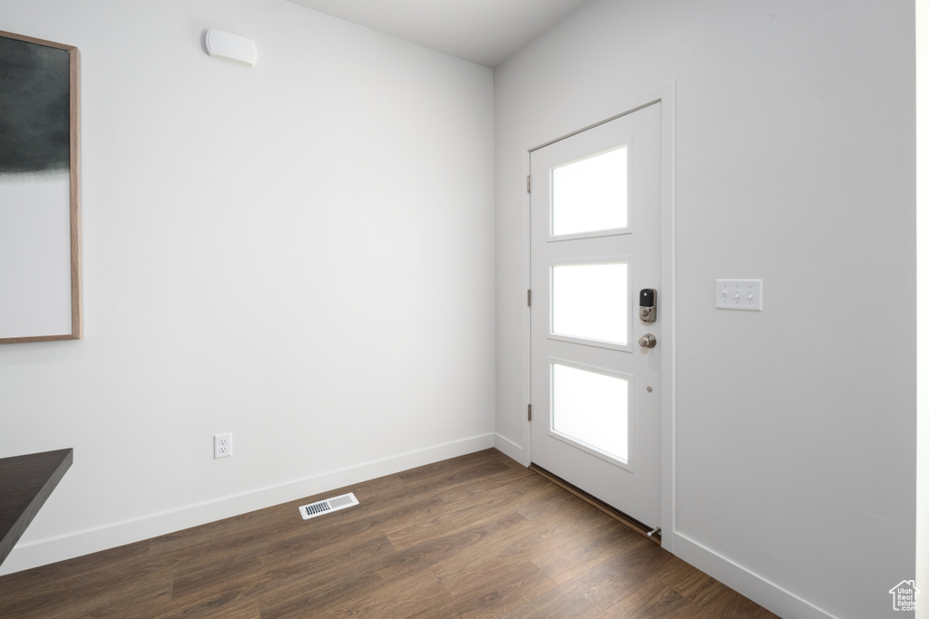 Interior space with baseboards, dark wood-style floors, and visible vents