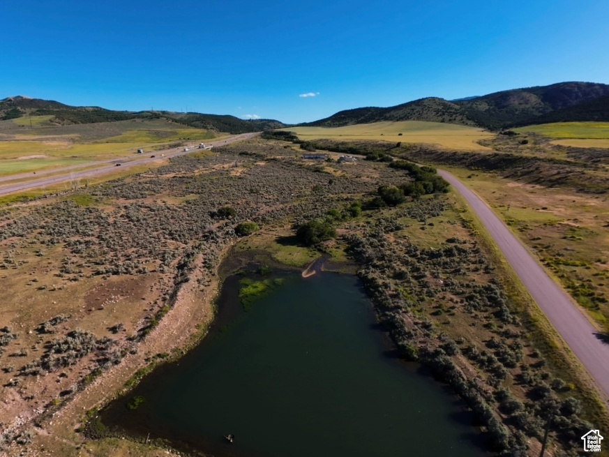 Aerial view featuring a water and mountain view
