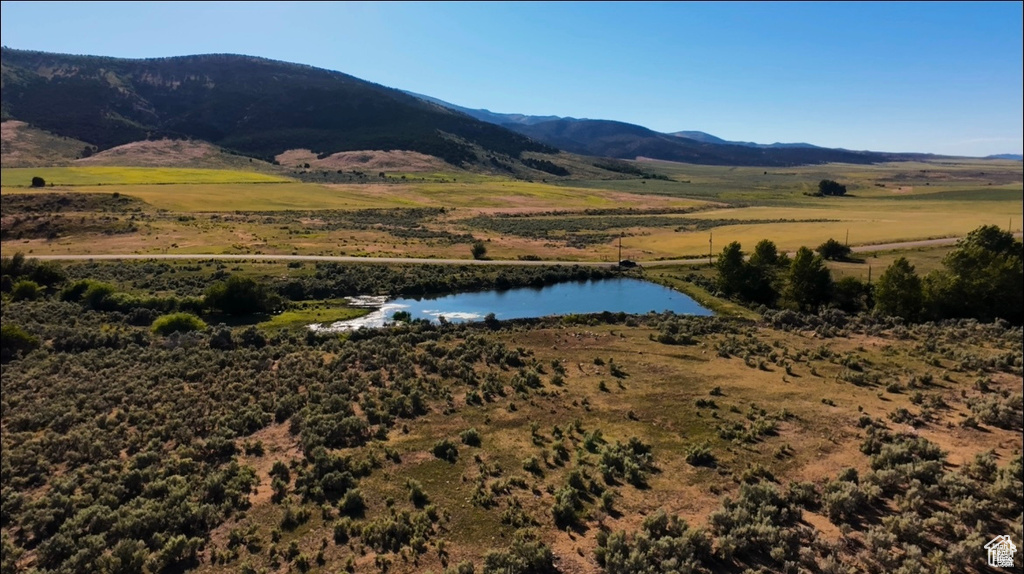 Property view of mountains featuring a water view