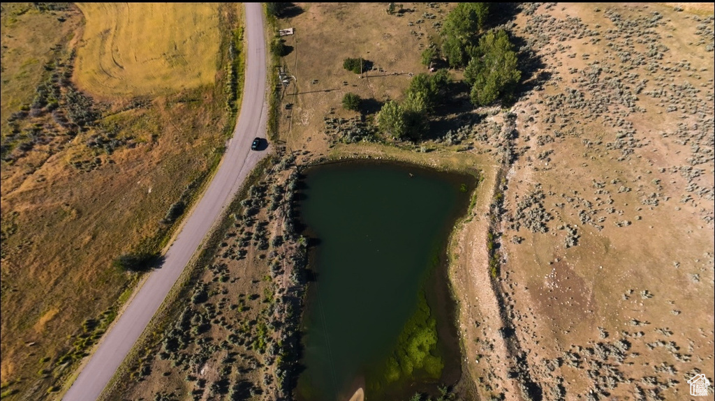 Birds eye view of property featuring a water view