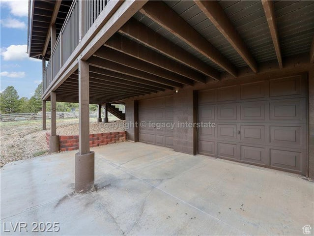 View of patio featuring a garage and a carport