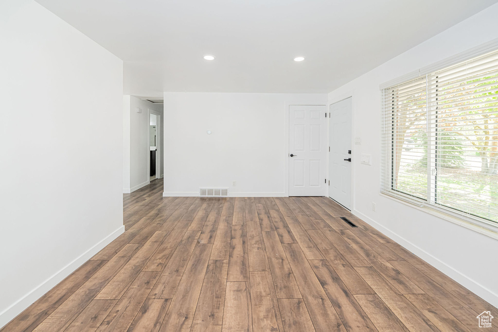 Spare room featuring recessed lighting, baseboards, hardwood / wood-style flooring, and visible vents