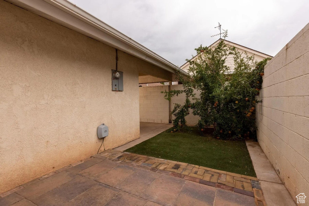 Exterior space with fence, a patio, and stucco siding