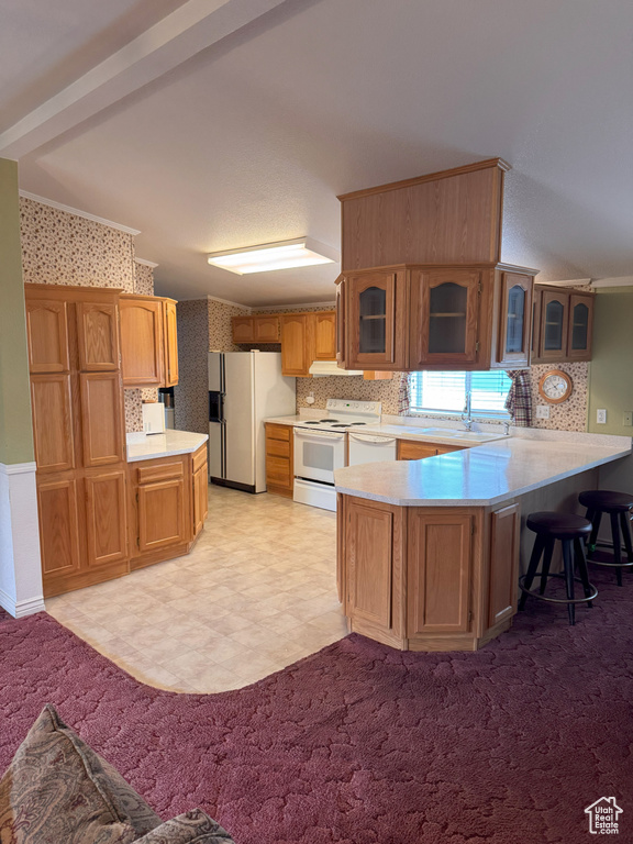Kitchen with decorative backsplash, a peninsula, white appliances, glass insert cabinets, and light countertops