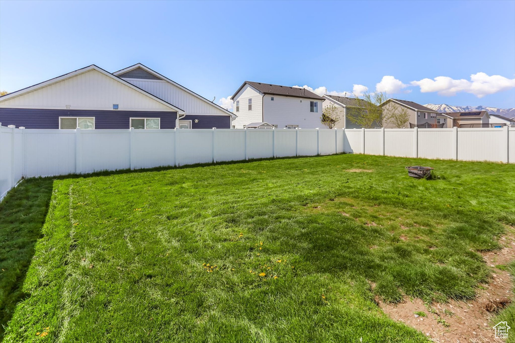 View of yard featuring a fenced backyard and a residential view