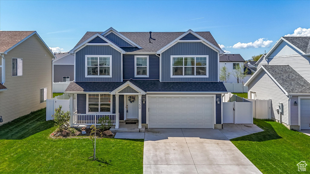 View of front of house featuring covered porch, board and batten siding, fence, an attached garage, and a shingled roof