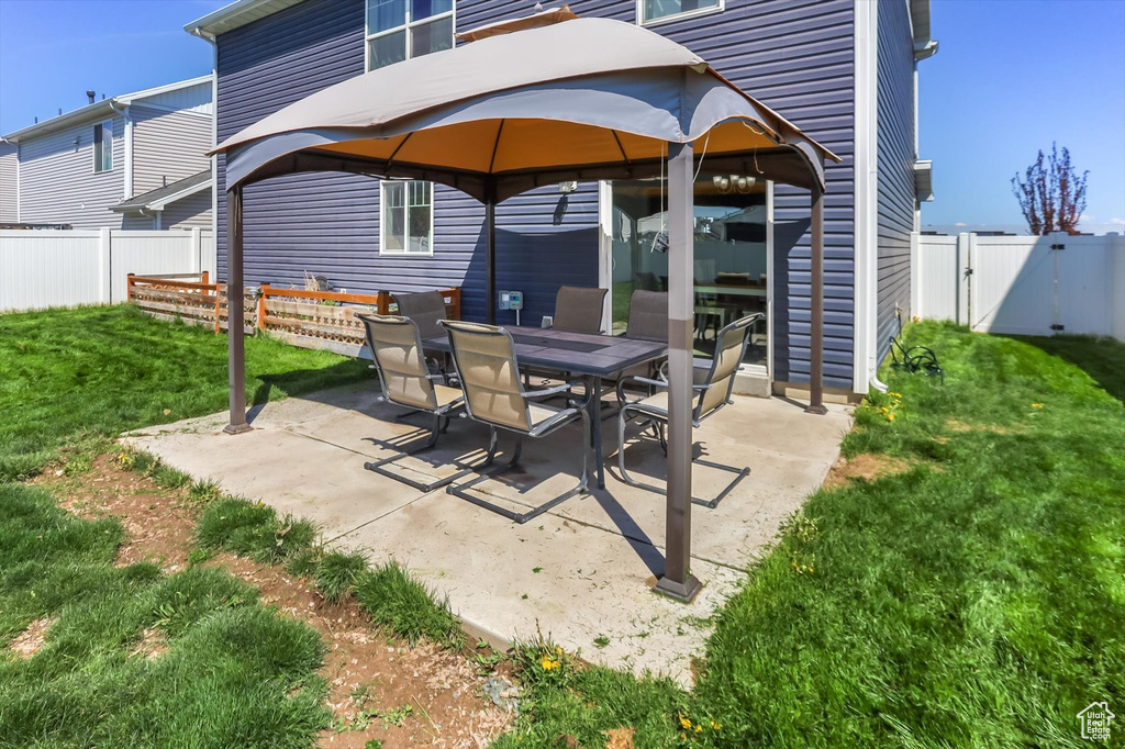 View of patio featuring a fenced backyard and a gazebo
