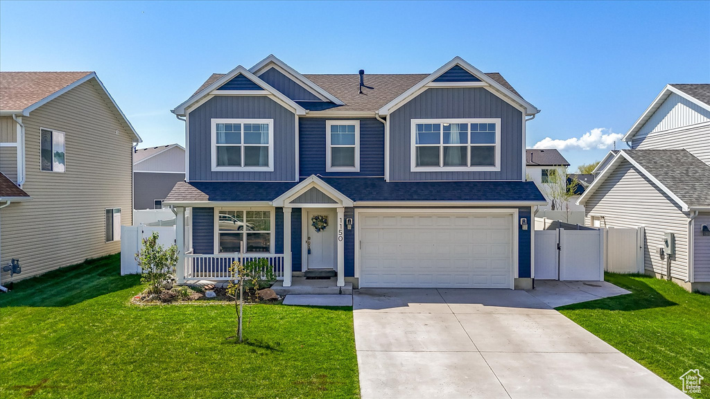 View of front of property with fence, board and batten siding, a porch, and driveway