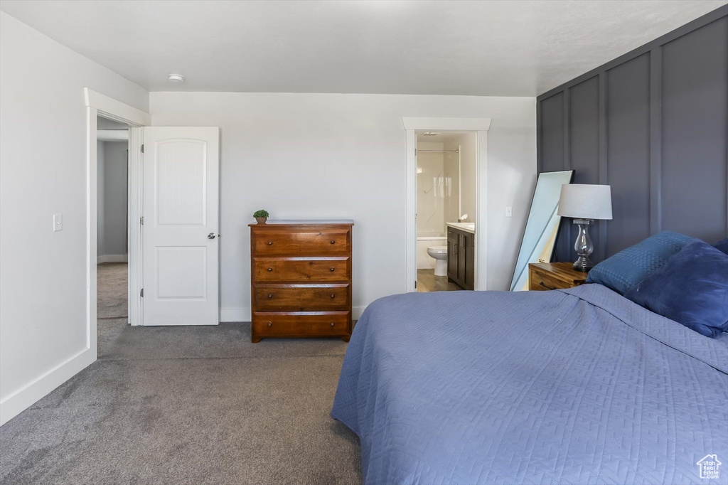 Bedroom featuring baseboards, carpet, and ensuite bath
