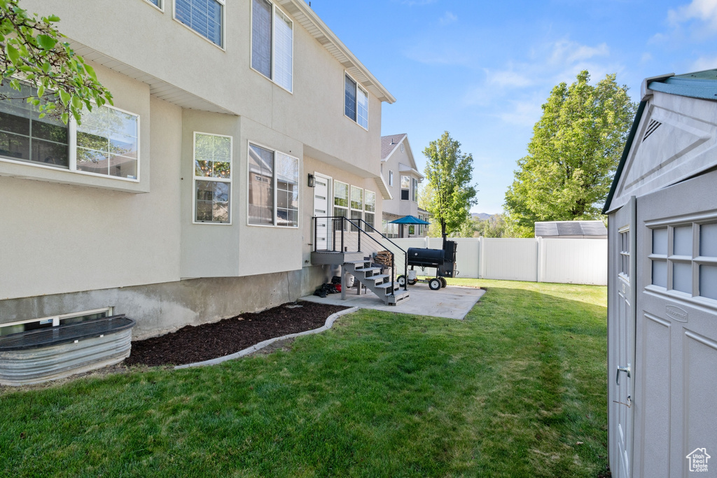 View of yard with a patio area and fence