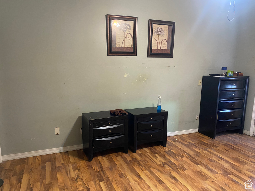 Bedroom featuring baseboards and wood finished floors