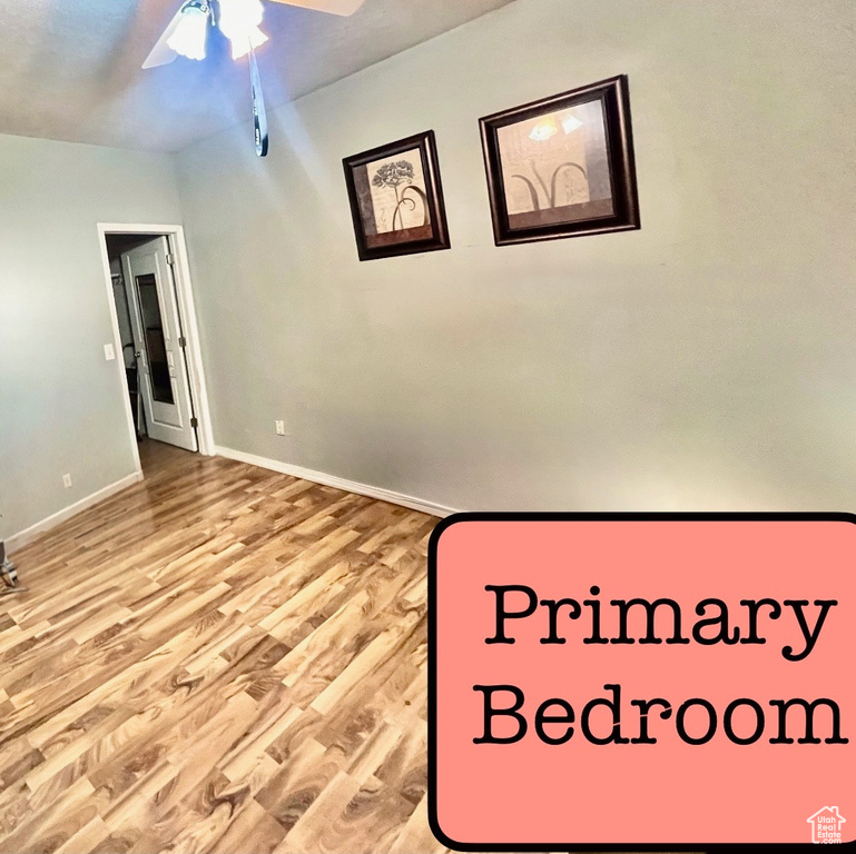 Unfurnished bedroom featuring baseboards, ceiling fan, and wood finished floors