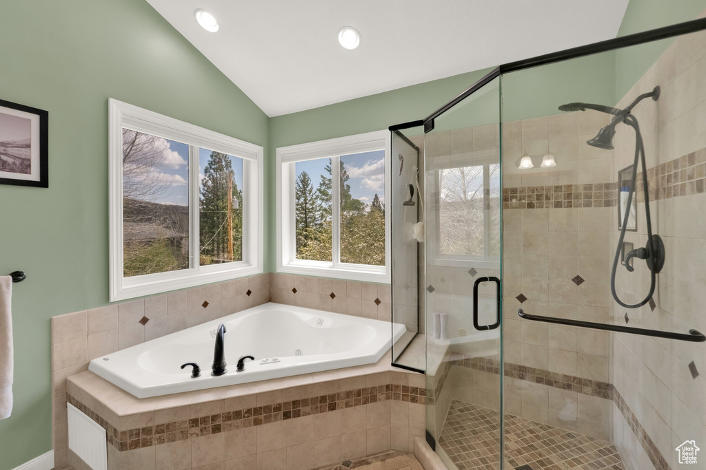 Full bathroom with recessed lighting, vaulted ceiling, a shower stall, and a garden tub