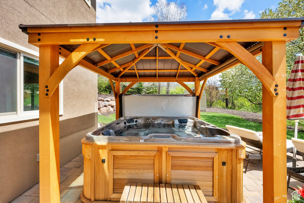 View of patio with a gazebo and a hot tub