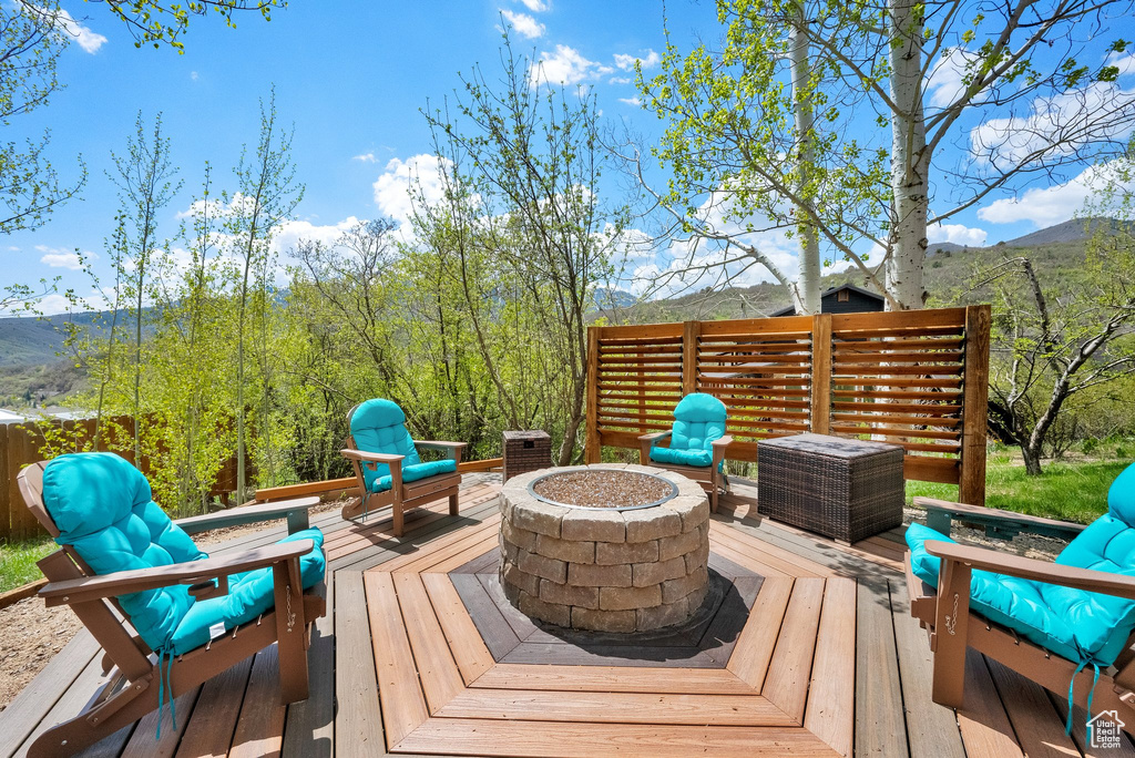 Deck featuring a mountain view and a fire pit