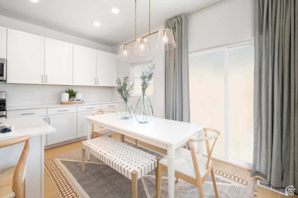 Kitchen featuring visible vents, light countertops, white cabinets, light wood-style floors, and recessed lighting