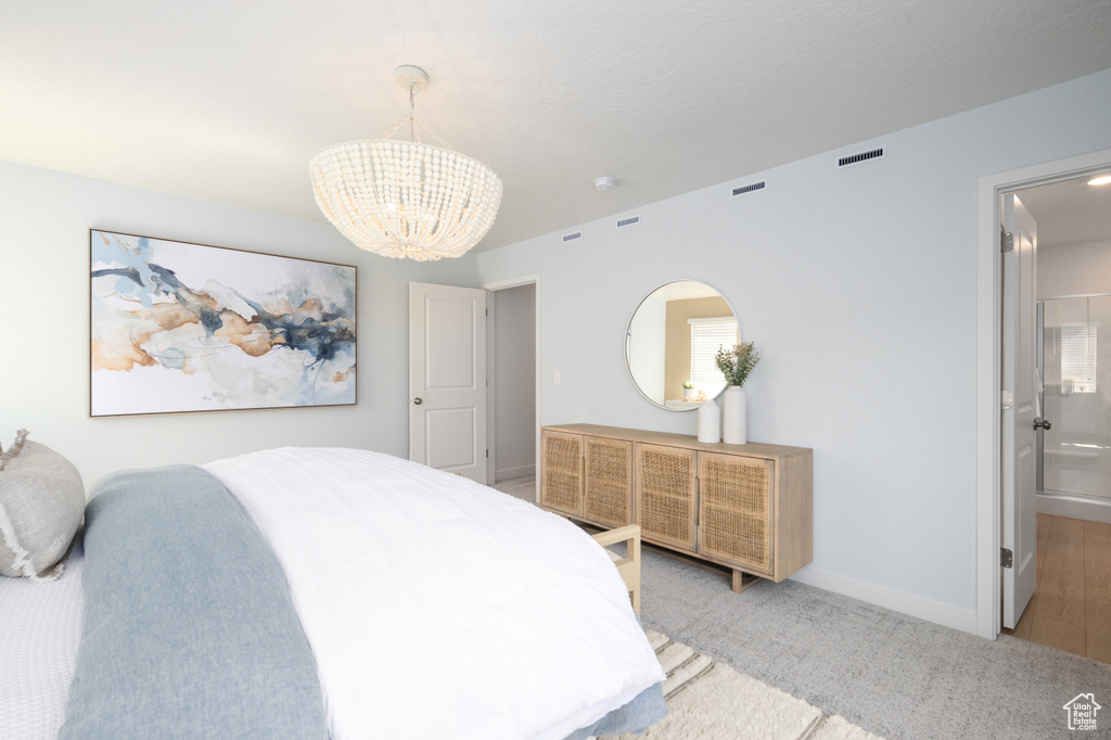 Bedroom with baseboards, a notable chandelier, carpet, and visible vents