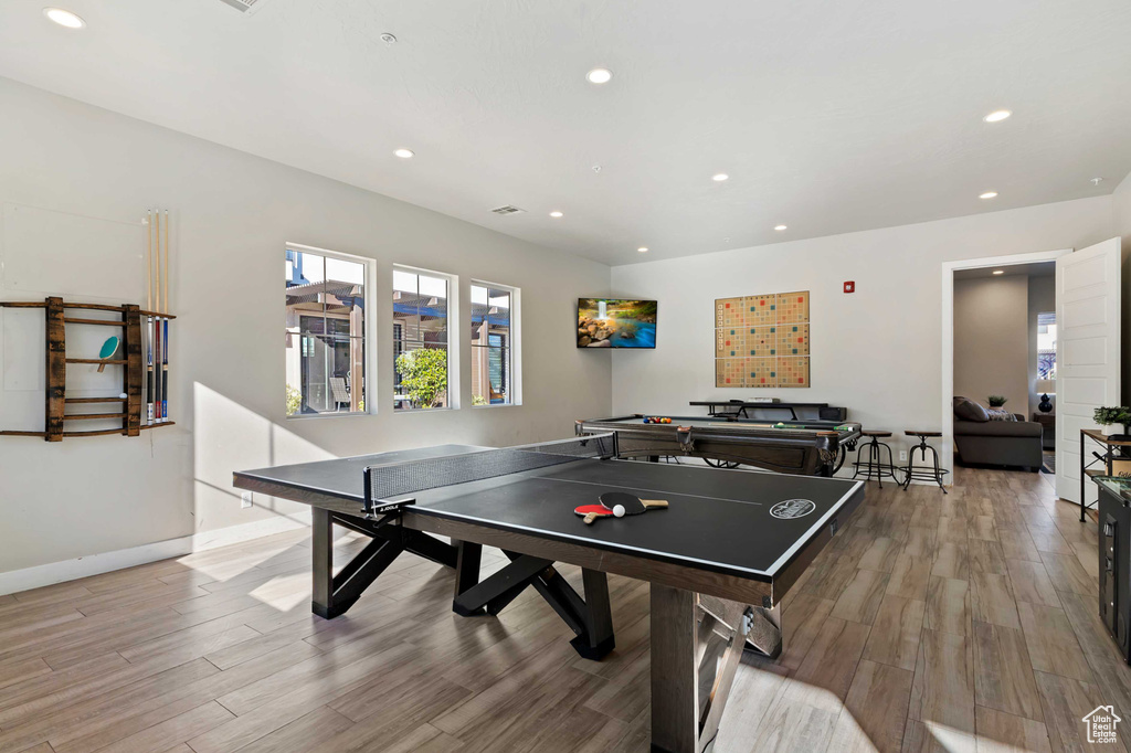 Rec room featuring recessed lighting, wood finished floors, and baseboards
