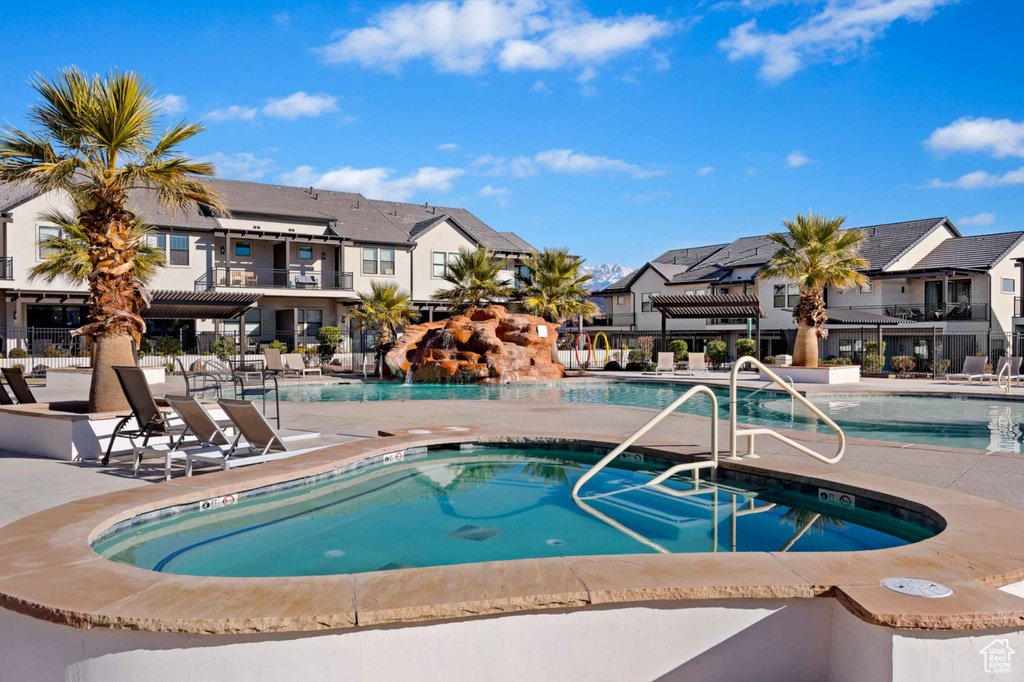 Community pool featuring a residential view, a patio, and fence