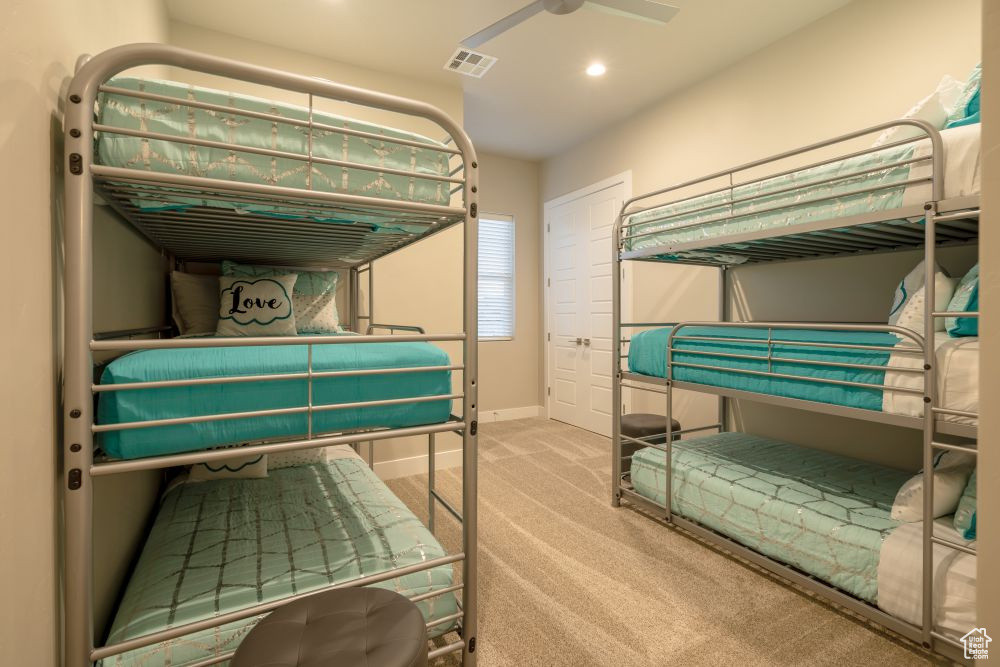 Carpeted bedroom featuring visible vents, recessed lighting, baseboards, and ceiling fan