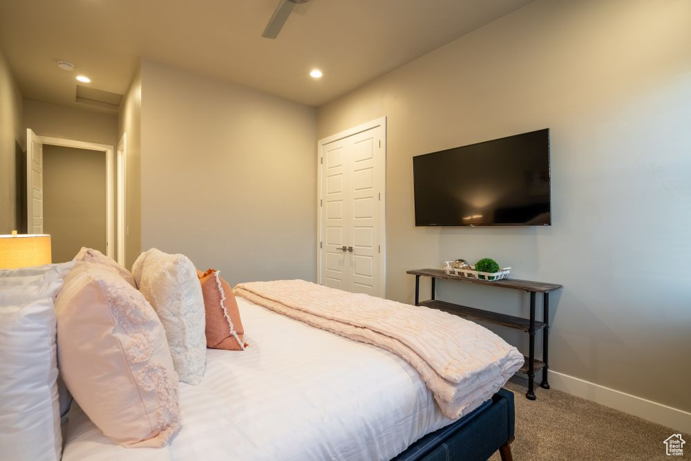 Carpeted bedroom featuring baseboards, a ceiling fan, attic access, and recessed lighting