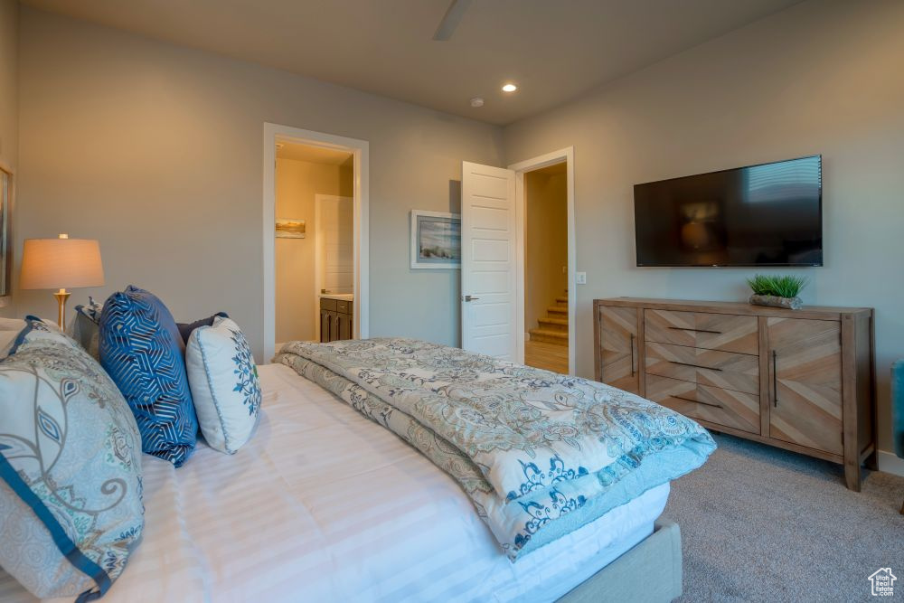 Bedroom with carpet floors, ensuite bathroom, a ceiling fan, and recessed lighting