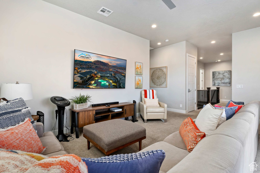 Carpeted living area with recessed lighting, baseboards, and ceiling fan