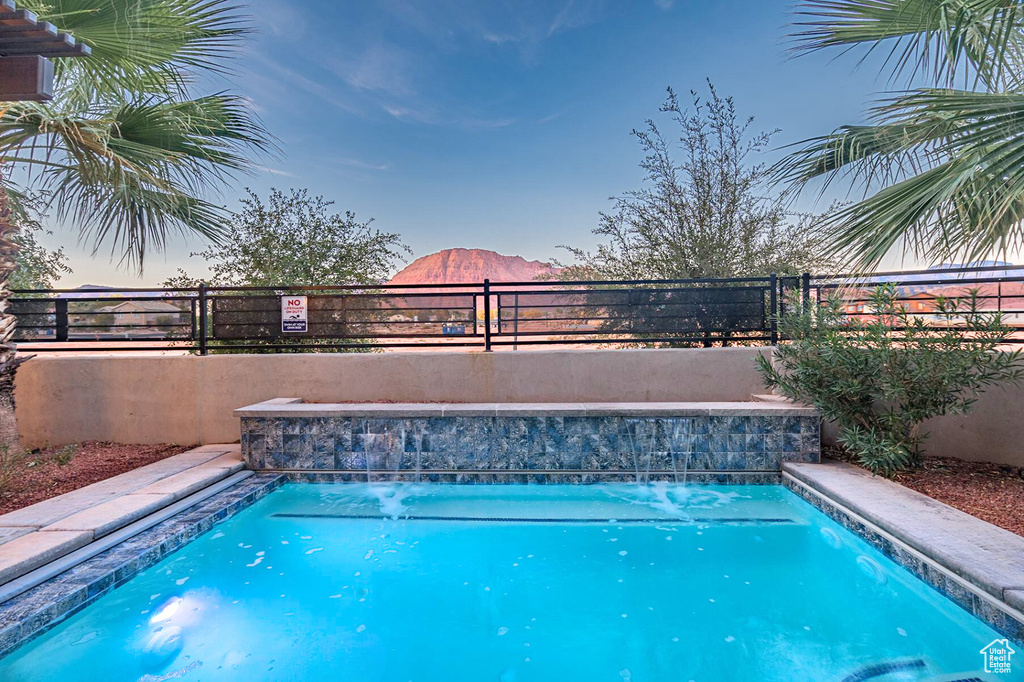 View of swimming pool featuring a fenced backyard and a mountain view