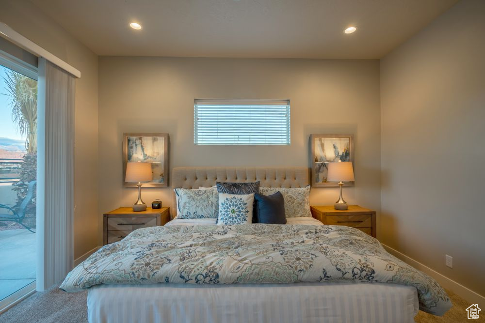 Carpeted bedroom featuring baseboards, recessed lighting, and access to exterior