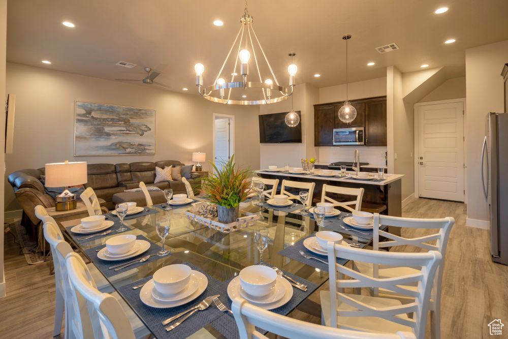 Dining room with recessed lighting, a notable chandelier, light wood finished floors, and visible vents