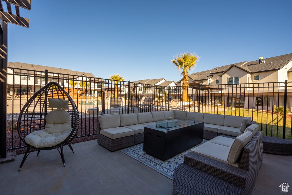 View of patio with an outdoor living space with a fire pit, a residential view, and fence