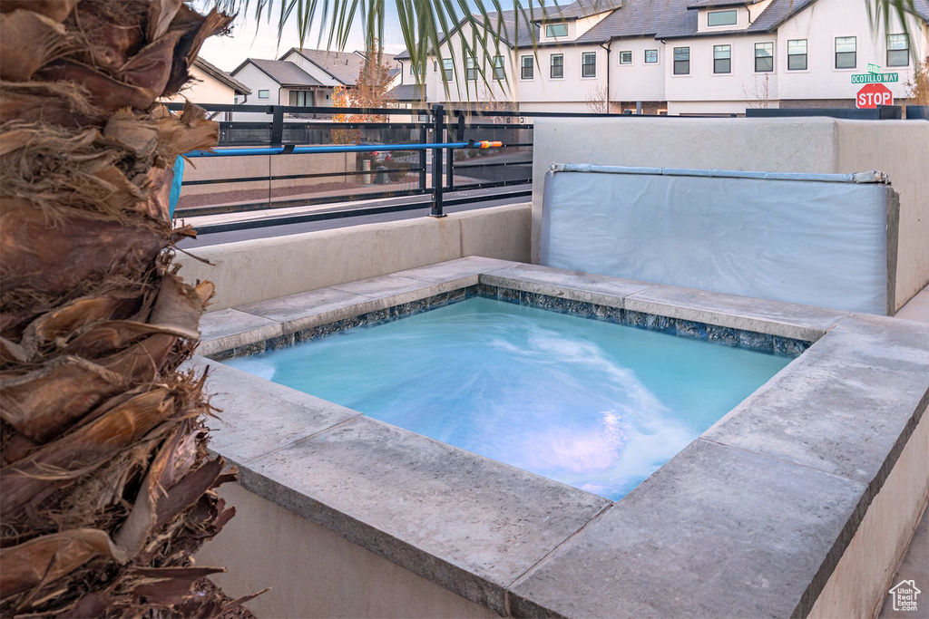 View of pool with an in-ground hot tub and a residential view