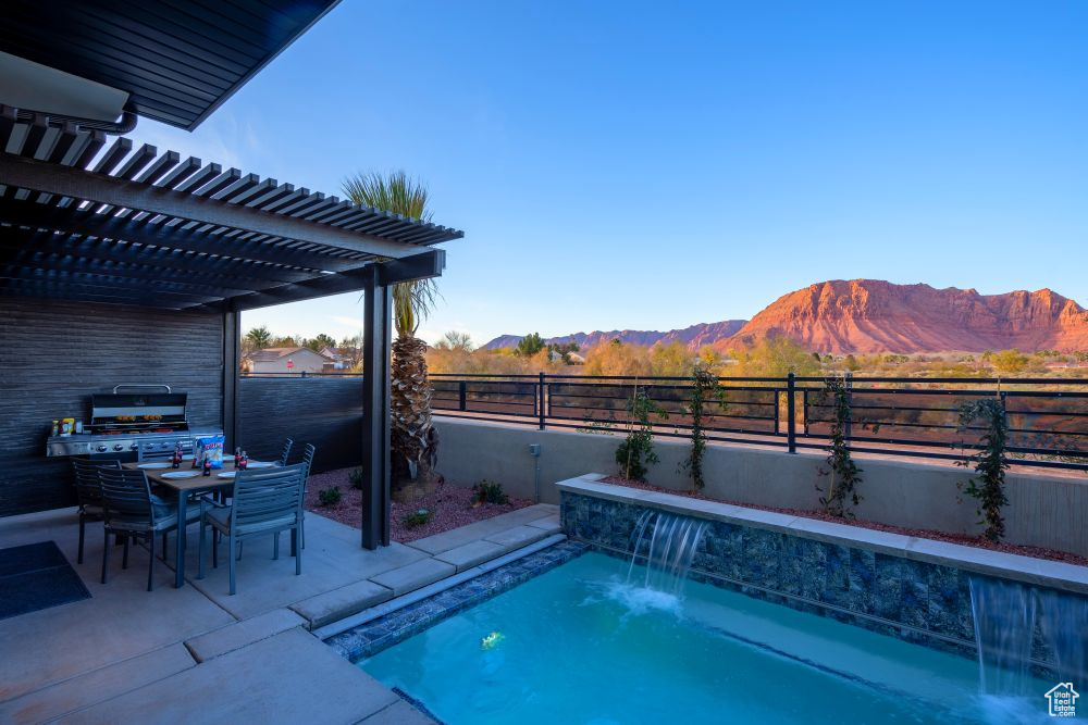 View of swimming pool featuring a pergola, a fenced in pool, a mountain view, and a fenced backyard