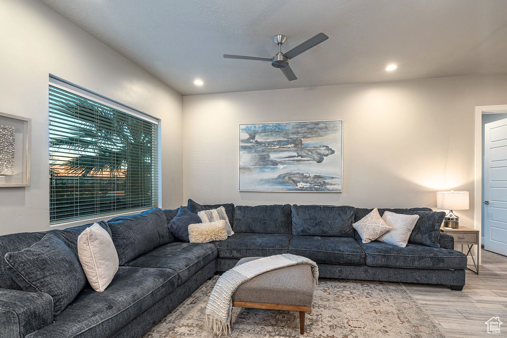Living area with wood finished floors, a ceiling fan, and recessed lighting