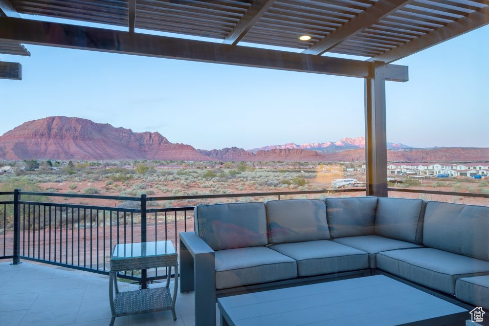 View of patio / terrace featuring a pergola, an outdoor living space, a mountain view, and a balcony