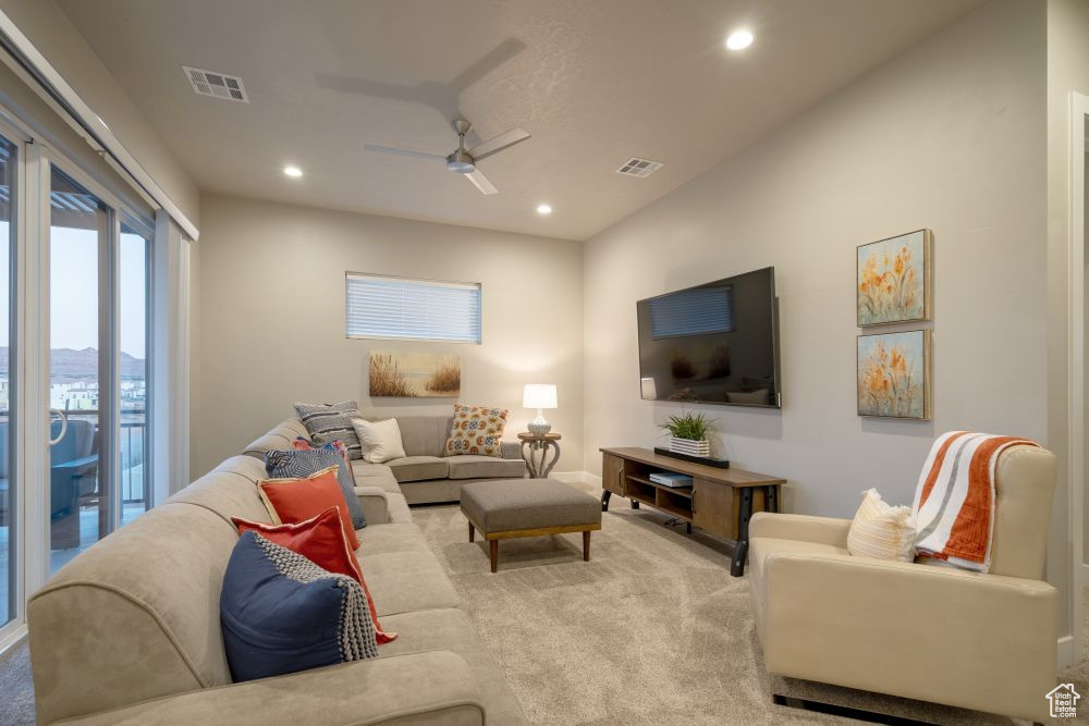 Living area with carpet, a ceiling fan, recessed lighting, and visible vents