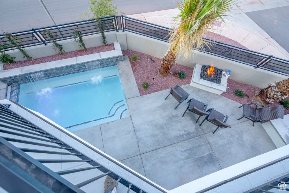 Outdoor pool featuring a fenced backyard and a patio area