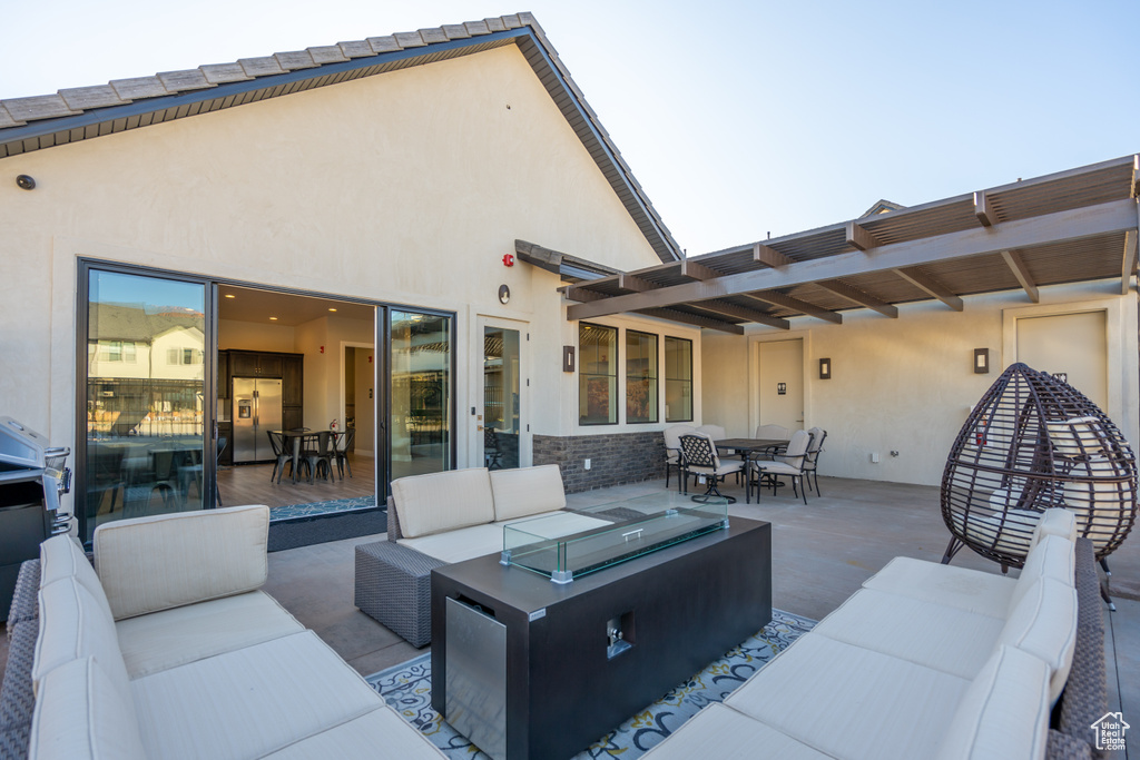 View of patio with an outdoor living space and outdoor dining area