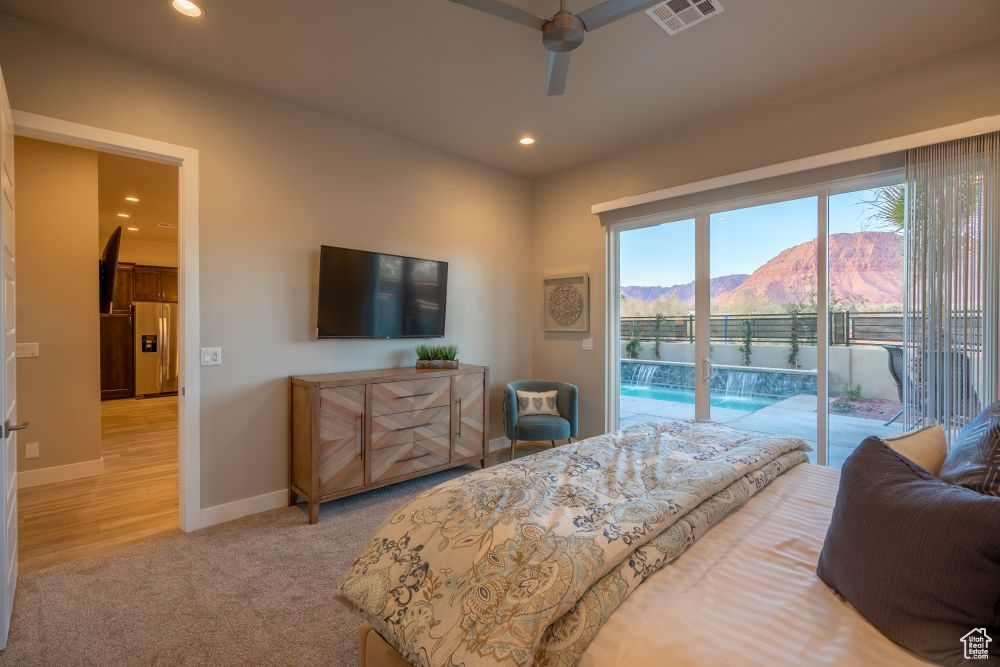 Bedroom featuring access to outside, light colored carpet, recessed lighting, stainless steel refrigerator with ice dispenser, and visible vents