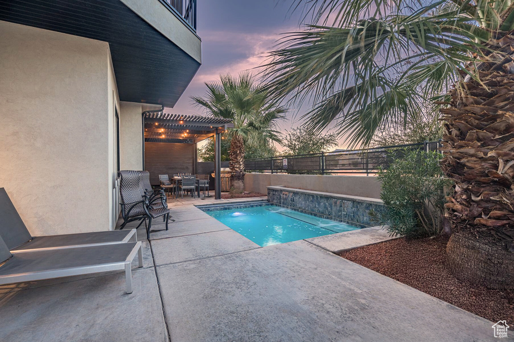View of swimming pool with outdoor dining area, a patio, a fenced backyard, and a pergola