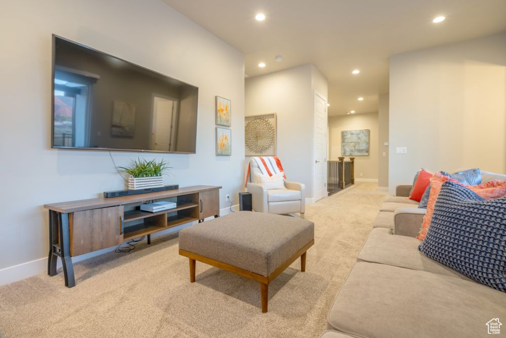 Living area featuring baseboards, carpet flooring, and recessed lighting