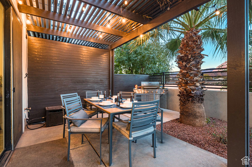View of patio / terrace featuring outdoor dining space, exterior kitchen, a pergola, fence, and grilling area
