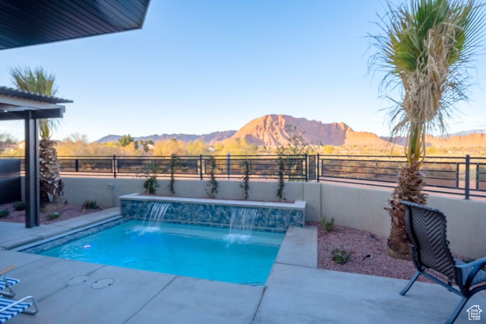 View of pool with a fenced in pool, a fenced backyard, a patio area, and a mountain view