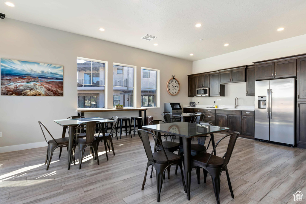 Dining space with recessed lighting, light wood finished floors, and baseboards