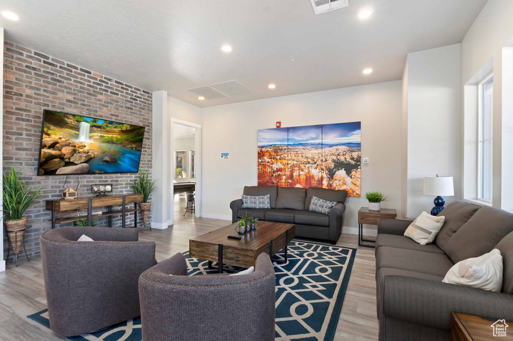 Living area featuring light wood-type flooring, recessed lighting, and baseboards