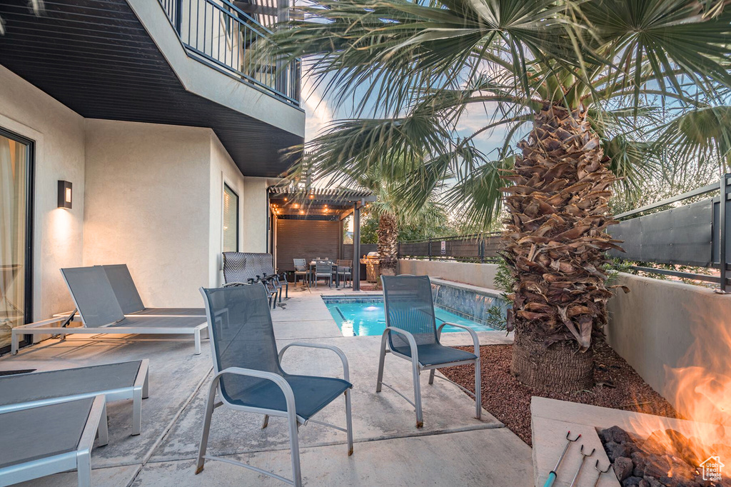 View of swimming pool with a fenced backyard and a patio area