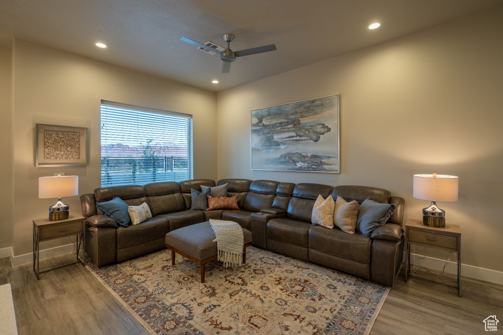 Living area featuring baseboards, a ceiling fan, wood finished floors, and recessed lighting