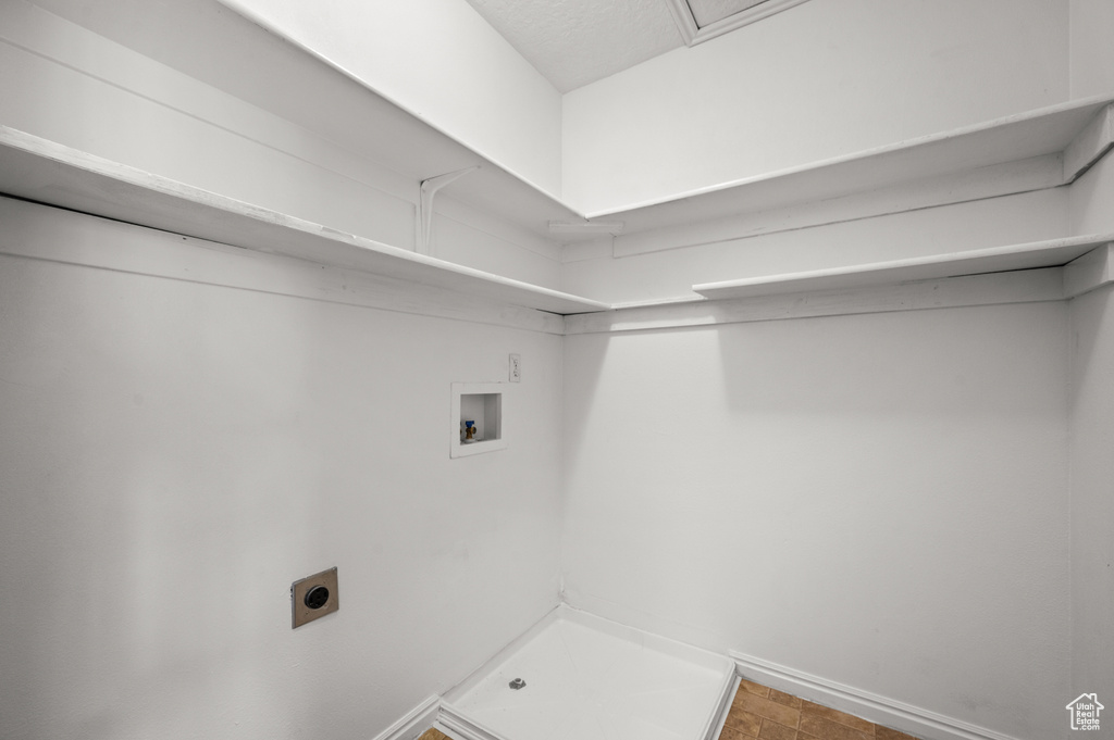 Laundry room featuring baseboards, laundry area, electric dryer hookup, and hookup for a washing machine