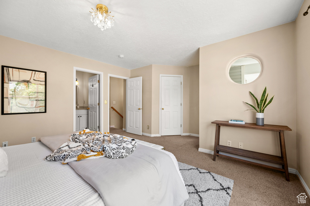 Bedroom featuring baseboards, carpet flooring, and connected bathroom